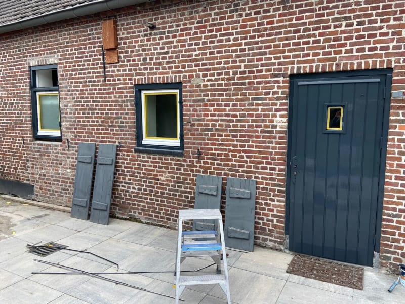 Picture showing the progress of the painting process, with painter's tape around the door and windows