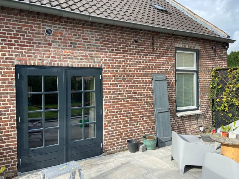 Finished image of dark paint on patio glass double door and windows