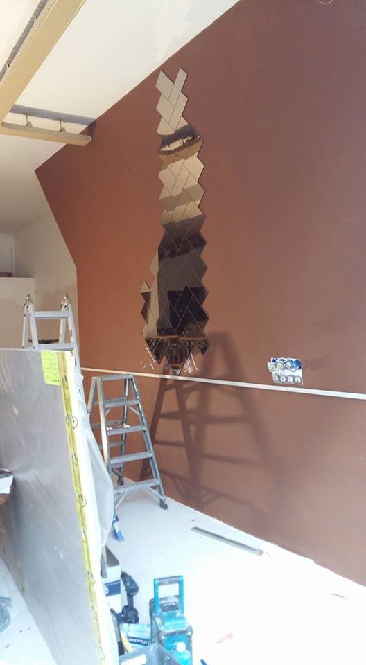 Rectangular-cut herringbone pattern mirror wall installation