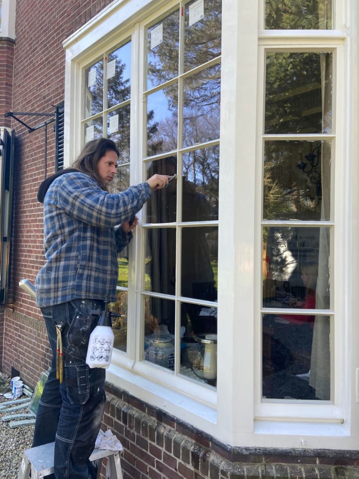 Old, broken sealant being stripped away from window by DEB professional