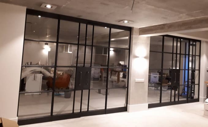 Basement ceiling-to-floor glass double-doors framed with steel