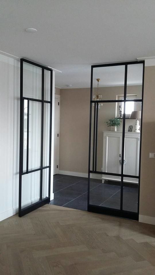 Living room ceiling-to-floor glass door framed with steel