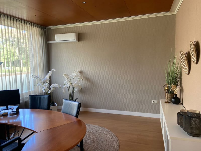 Wallpaper applied on an accent wall in an office room