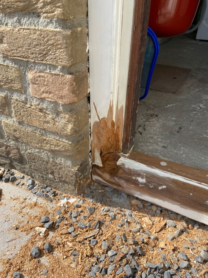 Decayed parts of left corner of door frame have been removed